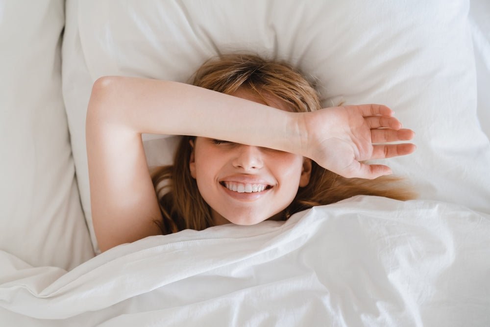 A person waking comfortably in bed